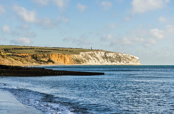 Looking across the sea to the golden cliffs at Yaverland Beach on the Isle of Wight