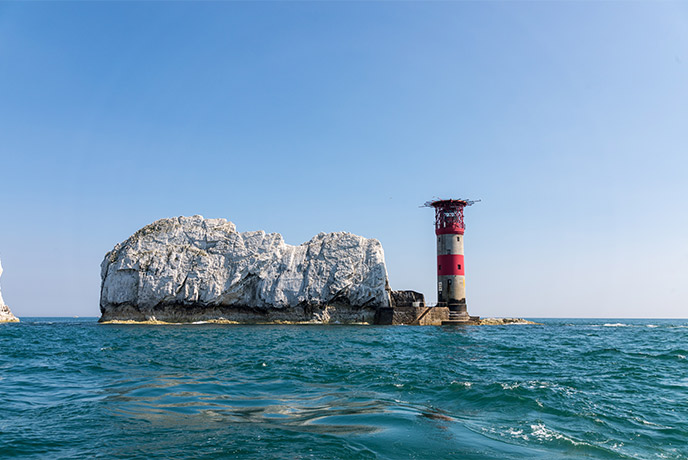 Looking out at The Needles rock stacks and lighthouse during a boat trip on the Isle of Wight